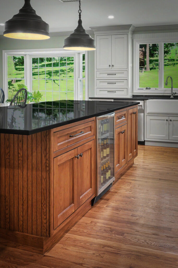Modern kitchen with wood island, black countertop, built-in wine fridge, pendant lights, and large windows.