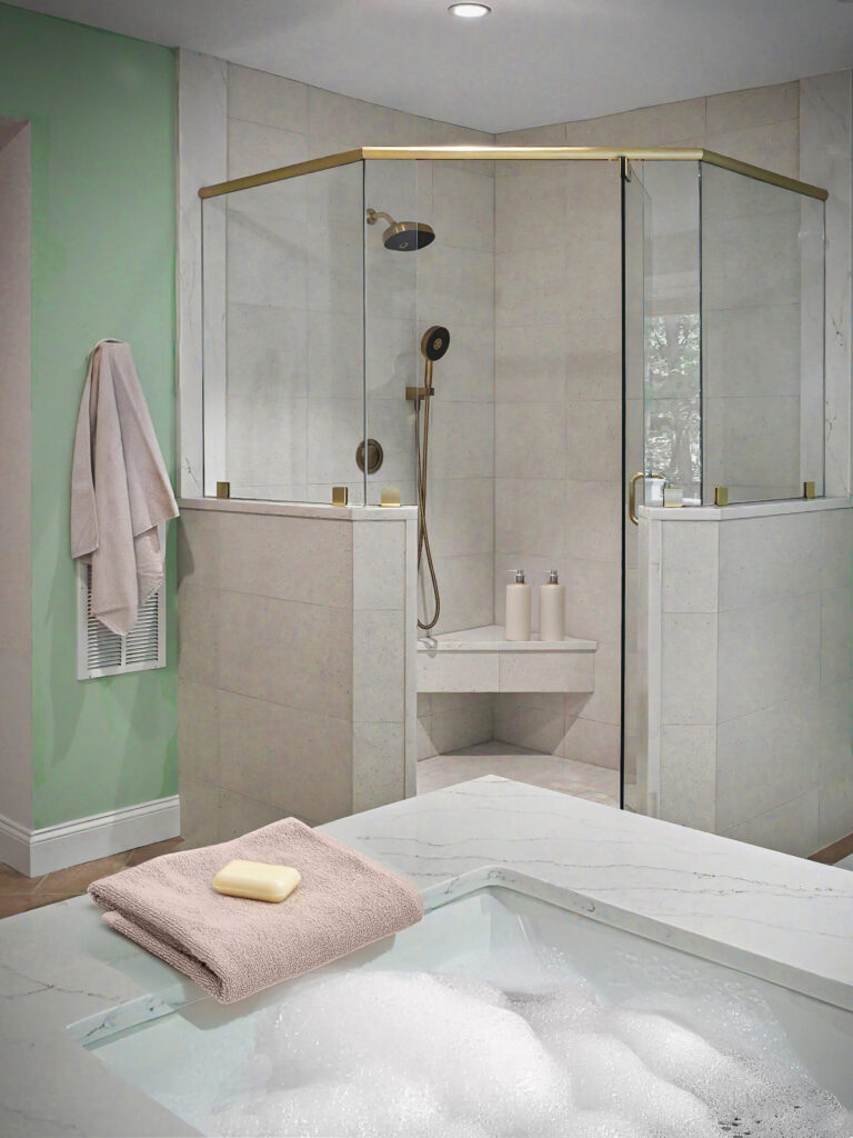A modern bathroom with a glass shower, a green wall, and a bubble-filled bathtub with a towel and soap on the edge.