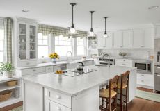 All white kitchen with wooden chairs