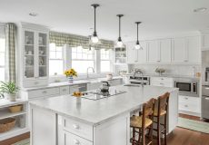 All white kitchen with wooden chairs